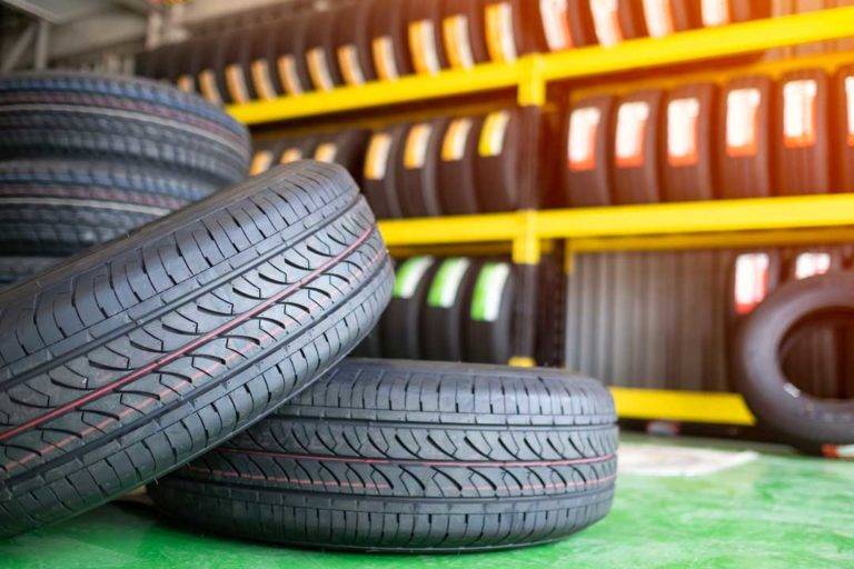 Stack Of New Tires In A Car Shop Garage. Tire Installation Service